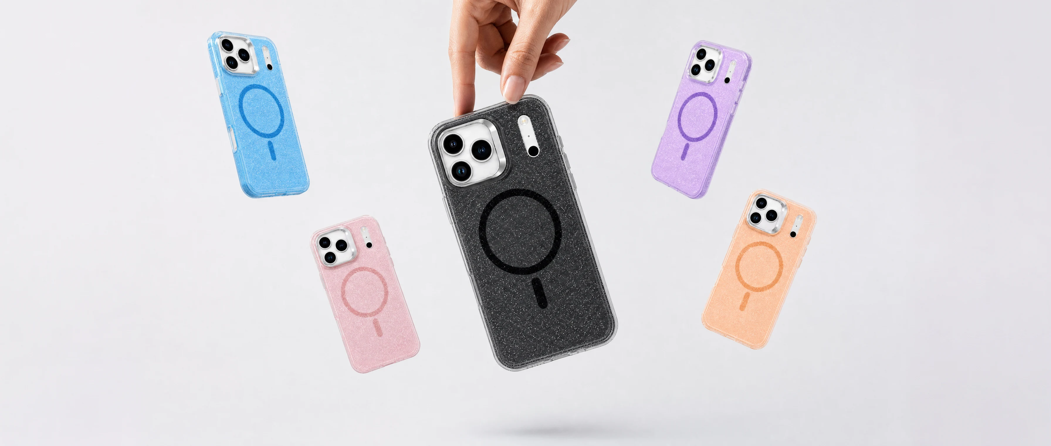 A hand lifts the black glitter MagSafe iPhone case out of a falling set of blue, pink, purple and peach glitter cases on a pale studio backdrop