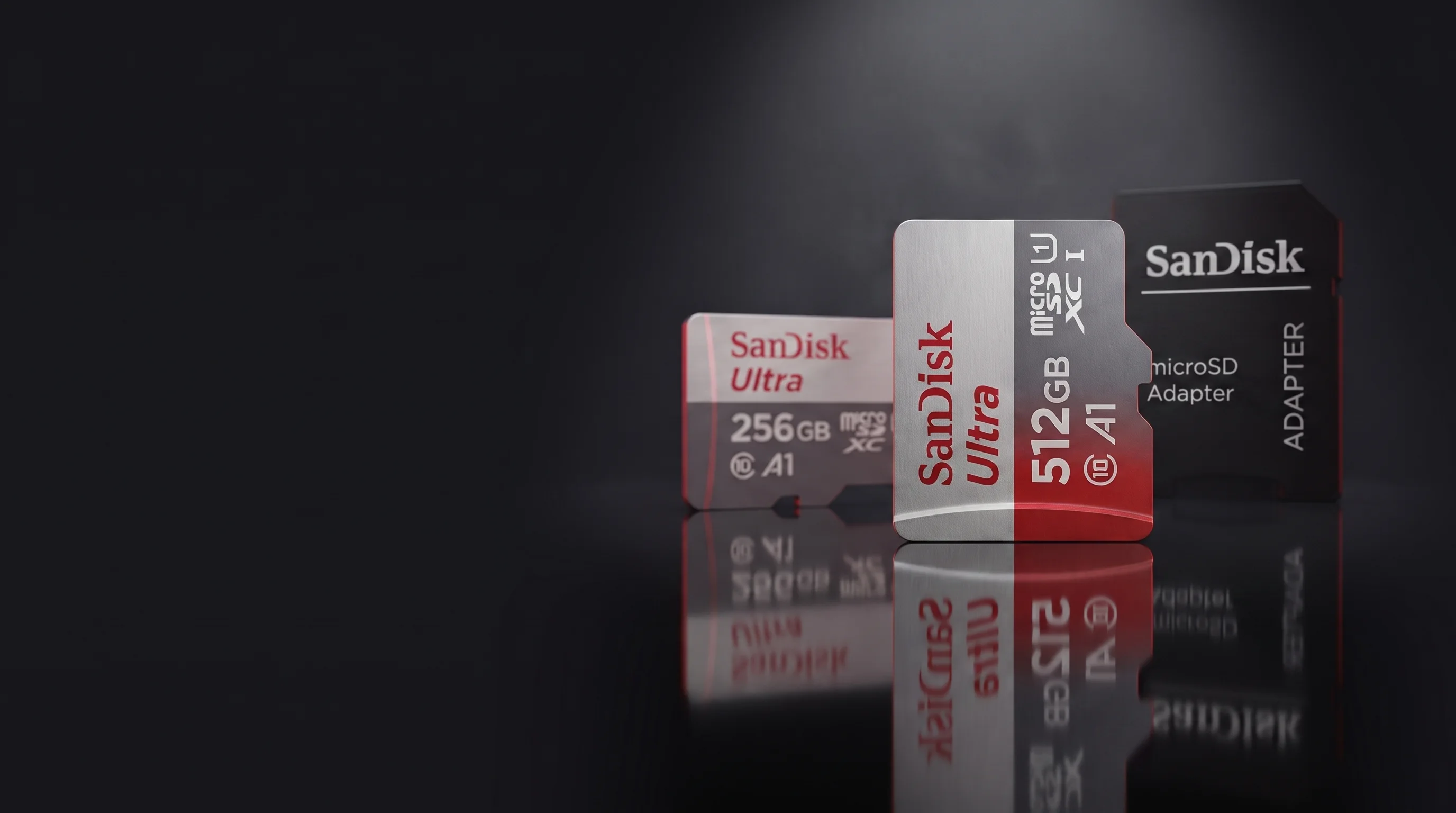SanDisk Ultra microSDXC cards in 256GB and 512GB with the SanDisk microSD adapter on a dark studio stage